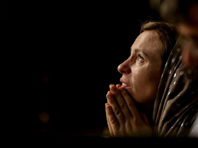ISTANBUL, TURKEY - JANUARY 06: A woman prays during a mass, leaded by Fener-Greek Patriarch Bartholomew I as part of celebrations of Jesus Christ's baptism and birth at the St. George's Cathedral (Aya Yorgi Church) in Istanbul, Turkey on January 6, 2017. Onur Coban / Anadolu Agency ONUR COBAN / …