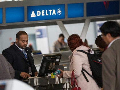 NEW YORK, NY - APRIL 23: Customers check in at Delta's counter at John F. Kennedy Airport on April 23, 2014 in the Queens borough of New York City. Delta released higher-than-expected quarterly earnings today, causing its stock to rise 5%. (Photo by Andrew Burton/Getty Images)