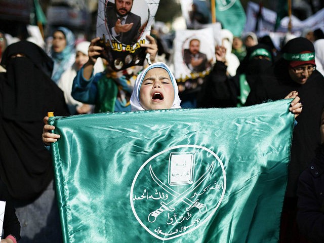 A girl carries a flag of the Muslim Brotherhood as she joins protesters from the Islamic Action Front during demonstration to show their solidarity with Palestinians and anger at a recent political arrest, after the Friday prayer in Amman November 28, 2014. REUTERS/Muhammad Hamed