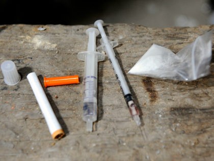 A bag of heroin and drug paraphernalia are seen at an abandoned house in Ljubljana, Slovenia, August 3, 2009. REUTERS/Bor Slana