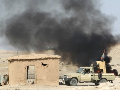 A picture taken on October 29, 2016 shows smoke billowing following a car bomb attack as Iraqi forces and the Hashed al-Shaabi (Popular Mobilisation) hold a position near the village of Ayn Nasir, south of Mosul, during the ongoing battle against Islamic State group jihadists to liberate the city of …
