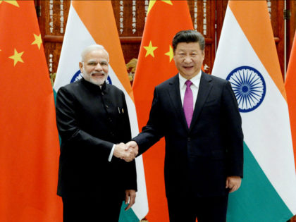 Indian Prime Minister Narendra Modi (L) shakes hands with Chinese President Xi Jinping at