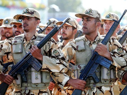 Iranian armed forces members march in a military parade marking the 36th anniversary of Ir