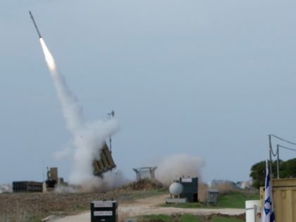 An Israeli soldier looks at an Iron Dome missile as it launched near the city of Ashdod, Israel, to intercept a rocket fired by Palestinians militants from Gaza Strip, Sunday, Nov. 18, 2012. Israeli strikes hit two media centers in the Gaza Strip on Sunday, as Israel warned it was …
