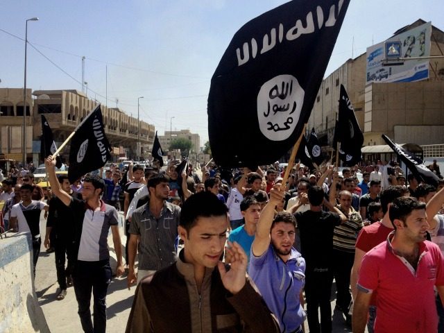 In this June 16, 2014 file photo, demonstrators chant pro-Islamic State group, slogans as