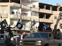 islamic-state-with-flags-syria-afp-photo An image made available by Jihadist media outlet Welayat Raqa on June 30, 2014, allegedly shows a member of the IS (Islamic state) militant group parading in a street in the northern rebel-held Syrian city of Raqa. AFP PHOTO / HO / WELAYAT RAQA === RESTRICTED TO EDITORIAL USE - …