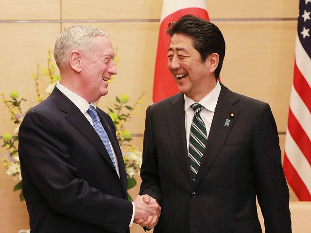 US Defense Secretary James Mattis (L) and Japanese Prime Minister Shinzo Abe (R) shake han