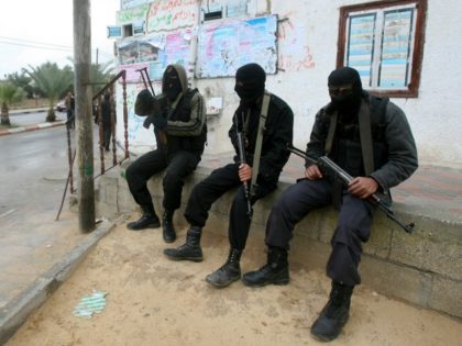 Islamic Jihad militants rest during the funeral of Haytham Arafat, in Khan Younis, souther