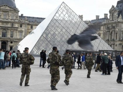 French soldiers enforcing the Vigipirate plan, France's national security alert system, patrol in front of the Louvre museum the day of its reopening on November 16, 2015 in Paris, three days after a series of deadly coordinated attacks claimed by Islamic State jihadists, which killed at least 129 people and …