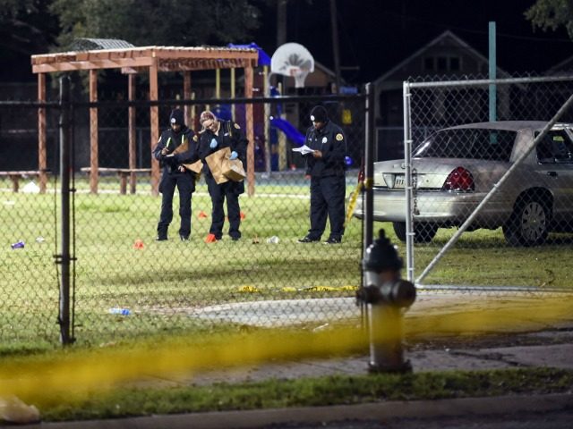 Police gather evidence after a shooting at a playground on November 22, 2015 in New Orleans, Louisiana. According to reports, as many as 16 people were shot at Bunny Friend Park while attending a party at a playground. (Photo by Cheryl Gerber/Getty Images)