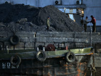 North Korean laborers work beside the Yalu River at the North Korean town of Sinuiju on February 8, 2013 which is close to the Chinese city of Dandong. US Secretary of State John Kerry warned that North Korea's expected nuclear tests only increase the risk of conflict and would do …