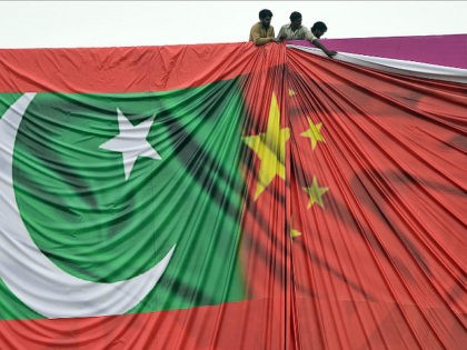Pakistan labourers arrange a welcome billboard featuring the Chinese and Pakistani nationa