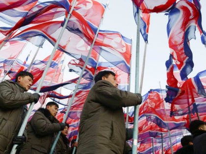 People march carrying flags of North Korea's Workers' Party during a rally in Pyongyang on Feb. 25, 2016, for a "70-day battle" ahead of the 7th Party Congress in May. (Kyodo via AP Images) ==Kyodo