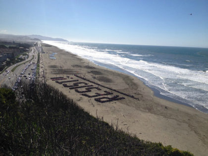Anti-Trump Protesters Gather on San Francisco Beach to Spell Out ‘ RESIST !!’