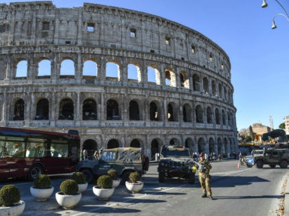 Italian military corps stand guard at a security check-point in front of ancient Colosseum, in central Rome on December 29, 2016. / AFP / Andreas SOLARO (Photo credit should read ANDREAS SOLARO/AFP/Getty Images)