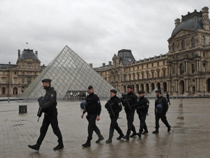 Armed police officers patrol in the courtyard of the Louvre museum near where a soldier opened fire after he was attacked in Paris, Friday, Feb. 3, 2017. A knife-wielding man shouting "Allahu akbar" attacked French soldiers on patrol near the Louvre Museum Friday in what officials described as a suspected …