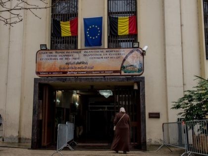 Belgian and EU flags arer displayed above the entrance to the Grand Mosque in Brussels on Match 25, 2016, as Muslims gathered for the first Friday prayers in the wake of the suicide attacks at Brussels airport and a metro station that left 31 people dead and 300 wounded and …