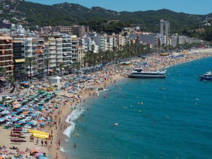 People enjoy the sea and beach in the Catalonian coastal city of Lloret de Mar, along the Mediterranean sea on August 7, 2016. / AFP / JOSEP LAGO (Photo credit should read JOSEP LAGO/AFP/Getty Images)