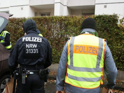 Policemen carry confiscated pieces of evidence to their car after raiding an apartment building in Bonn, western Germany, on November 15, 2016. German police said it carried out sweeping raids across 10 states in a probe against an Islamist group suspected of propagating hate and inciting youths to fight alongside …