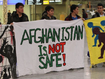 Demonstrators protest against the deportation of refugees back to Afghanistan at the airpo
