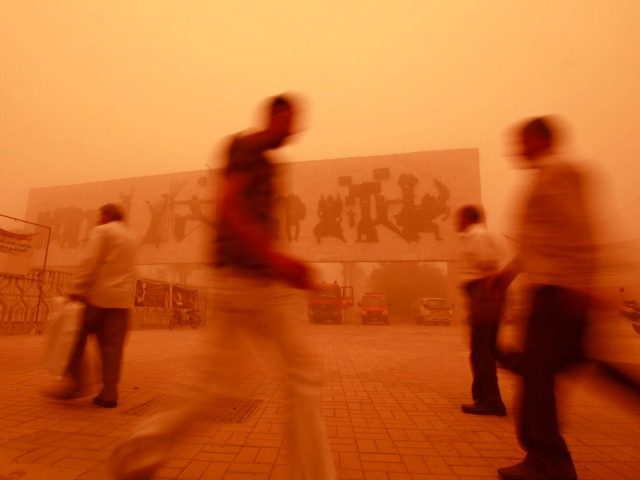 Iraqis walk through Tahrir Square during a heavy sandstorm in Baghdad, Iraq, Tuesday, May