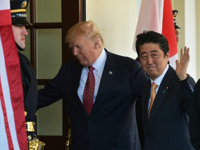 US President Donald Trump greets Japan's Prime Minister Shinzo Abe as he arrives outside o