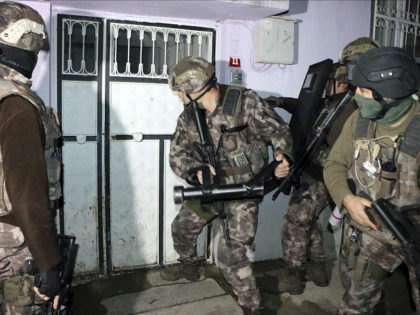 Turkish anti-terrorism police break a door during an operation to arrest people over alleged links to the Islamic State group, in Adiyaman, southeastern Turkey, early Sunday, Feb. 5, 2017. Turkey's state-run agency says anti-terrorism police have detained more than 400 people in simultaneous police operations that spanned several cities, including …