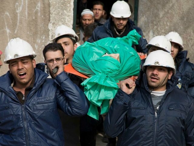In this Wednesday, Sept. 16, 2015 file photo, comrades carry Ilias Mahmoud al-Taweel, a me