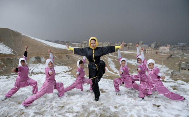 Afghan members of a wushu martial arts group led by trainer Sima Azimi (C) train at the Sh