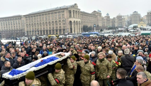 Mourners gather in Kiev's Independence (Maidan) Square on February 1, 2017, as servicemen