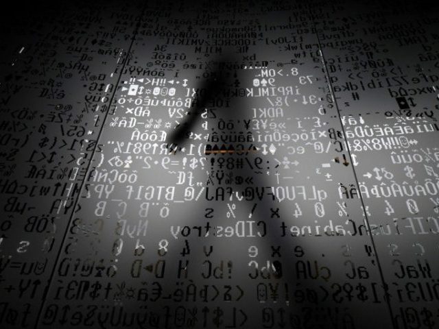 An employee walks past a glass panel at the Moscow headquarters of Kaspersky Lab, whose to
