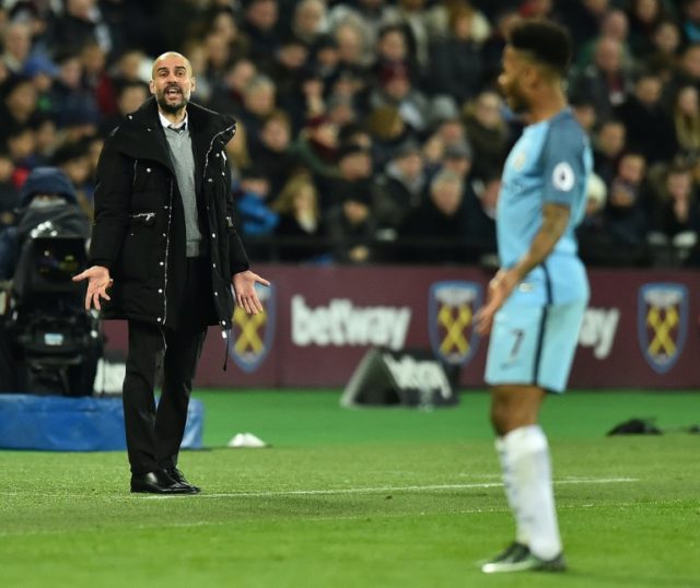 Manchester City's manager Pep Guardiola (L) shouts instructions to Manchester City's midfi