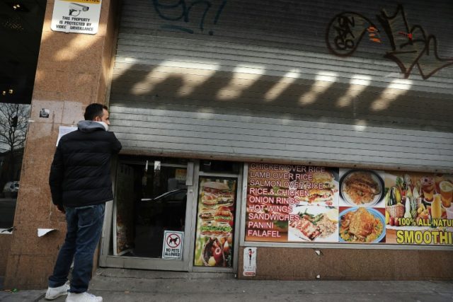 Yemeni business owner Musa closes the gate to his store on February 2, 2017 in the Brookly