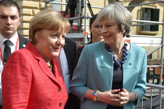 British Prime Minister Theresa May (R) and German chancellor Angela Merkel meet at a summi