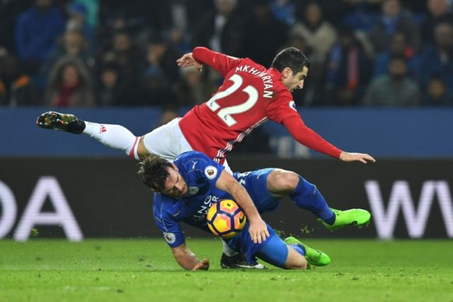 Leicester City's defender Christian Fuchs vies with Manchester United's midfielder Henrikh