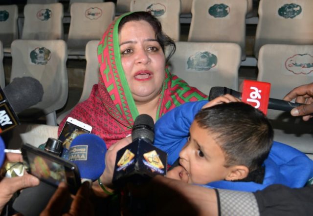 Pakistani mother Rohina Kiani holds her son Ifthikar Ahmed after he was handed over by an