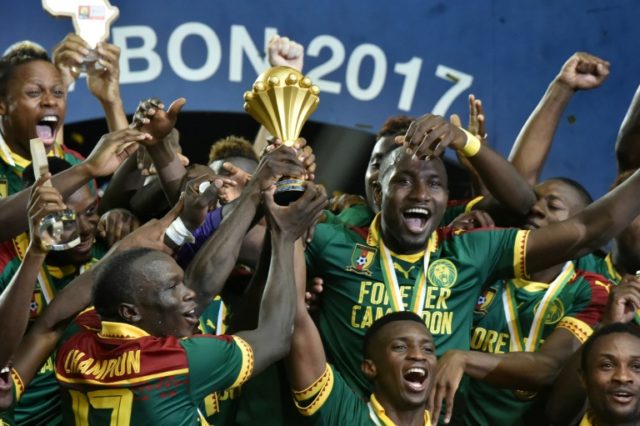 Cameroon's players celebrate with the winner's trophy after defeating Egypt 2-1 to win the
