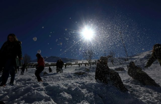 People play in the snow at the Korek Mountain resort near the city of Rawanduz in the Arbi