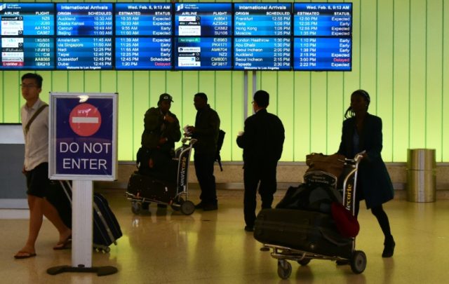 People arrive at the international terminal of Los Angeles International Airport on Februa
