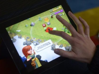 A woman plays 'Clash of Clans' on a tablet computer in Helsinki