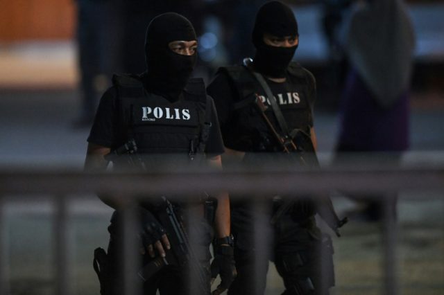 Malaysian special forces keep guard at the hospital holding the body of Kim Jong-Nam, the