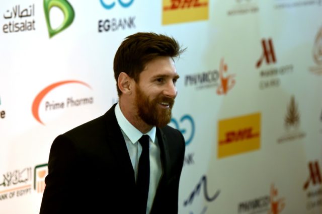 Barcelona's striker Lionel Messi arrives for a press conference in Cairo's northern Giza d