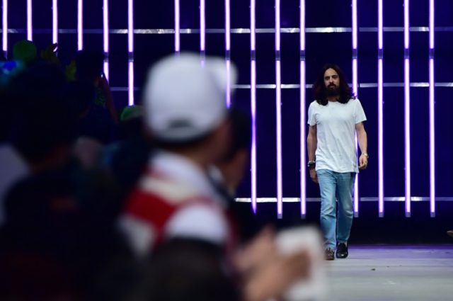 Designer Alessandro Michele greets the audience at the end of the show for fashion house G