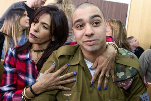 Israeli soldier Elor Azaria is embraced by his mother at the start of his sentencing heari