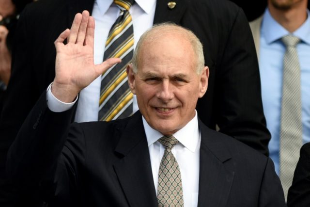 US Secretary of Homeland Security, John Kelly (C), waves after holding a meeting with Guat