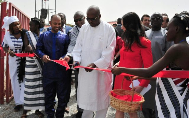President of Burkina Faso Roch Marc Christian Kabore (C) cuts the ribbon during the inaugu