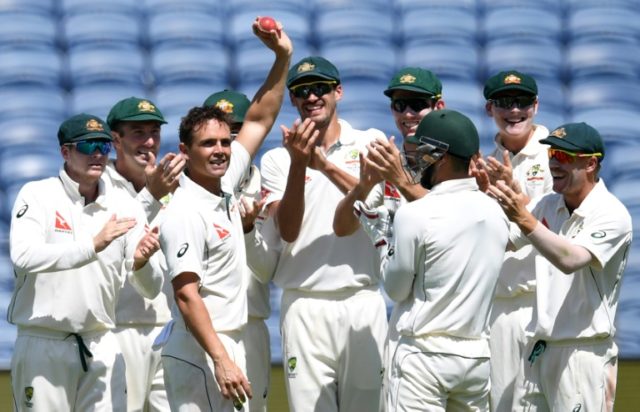 Australia's cricketers applaud teammate Steve O'Keefe (3rd L) after he took six wickets in