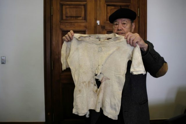Pan Hsin-hsing shows the vest his father was wearing when he was executed during the Febru