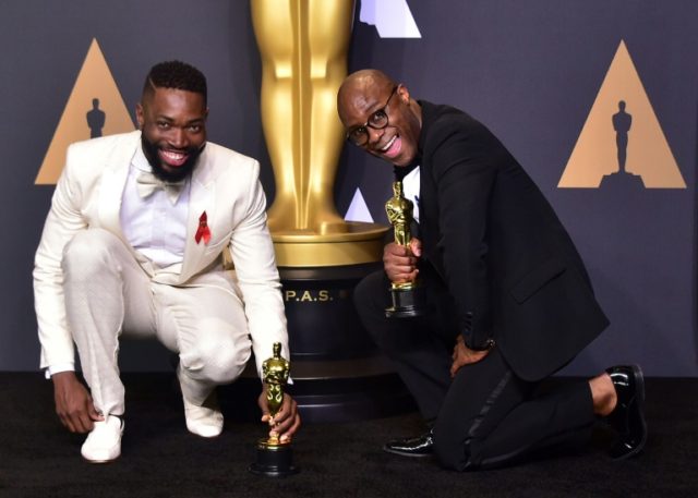 Writer/director Barry Jenkins (L) and writer Tarell Alvin McCraney pose with the Best Adap