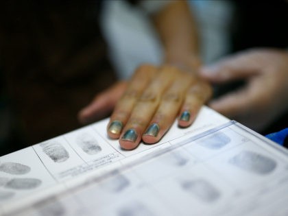 Fingerprints of a migrant are taken during registration at the Patrick-Henry Village refugee center, a former U.S. military facility in Heidelberg, Germany, September 29, 2015. REUTERS/Ralph Orlowski